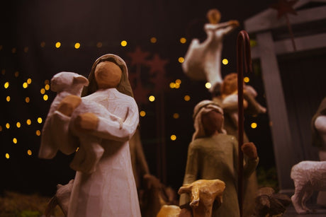 Wooden nativity scene with figures and glowing lights