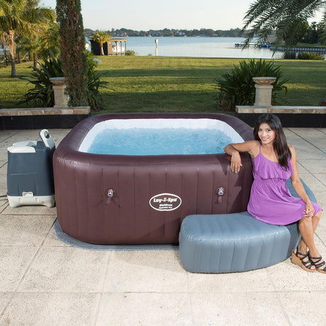 Woman sitting beside an inflatable Lay-Z-Spa hot tub outdoors