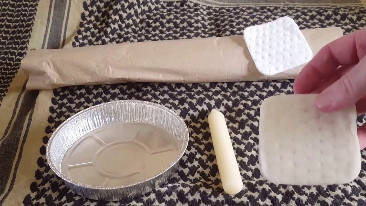 Materials for making fire starters: aluminum tray, candle, paper, and cotton pads